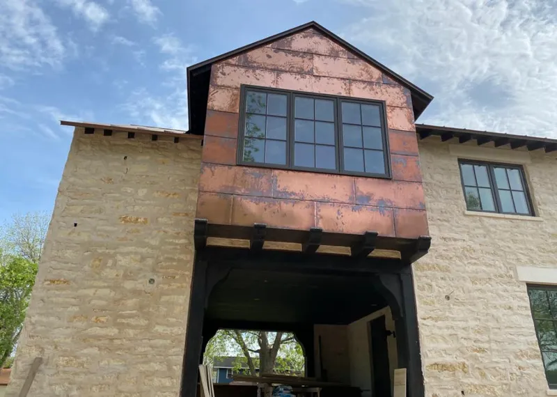 Copper metal panel facade on a stone building for Metal Roof Coating in Eagle Lake