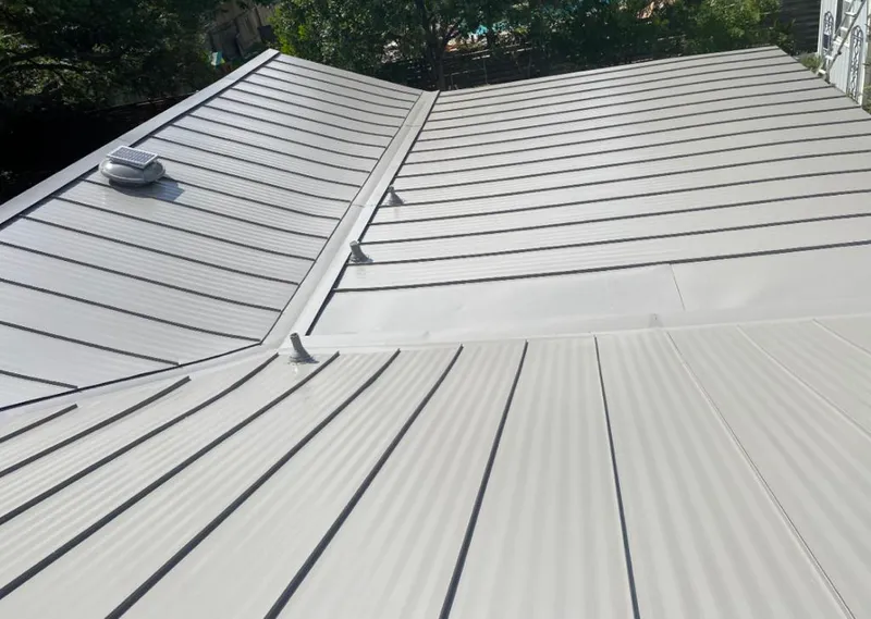 Solar attic fan installed on a metal roof for Roof Ventilation in Eagle Lake