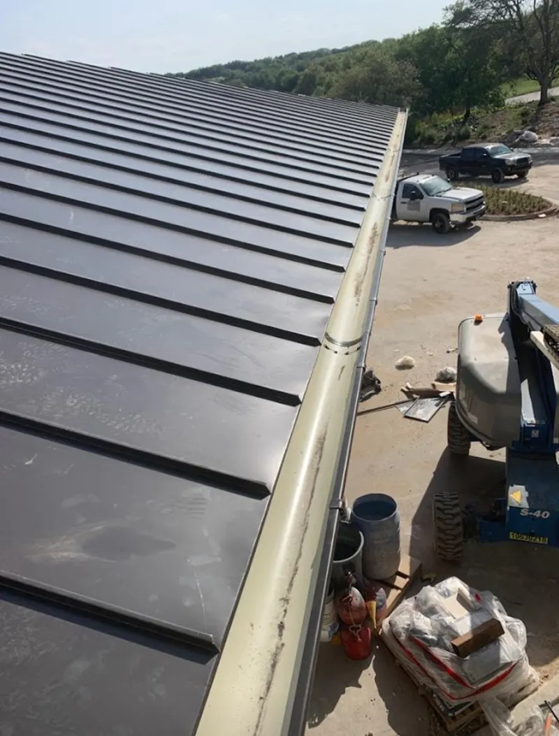 Standing seam panel and gutter detail on a metal roofing jobsite in Eagle Lake